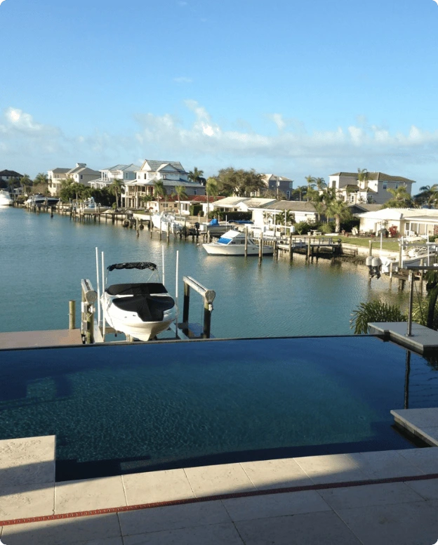 Waterfront Curtis Pools swimming pool overlooking a Florida canal